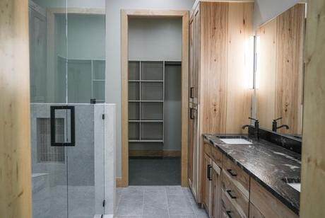 Tiled shower, closet beyond